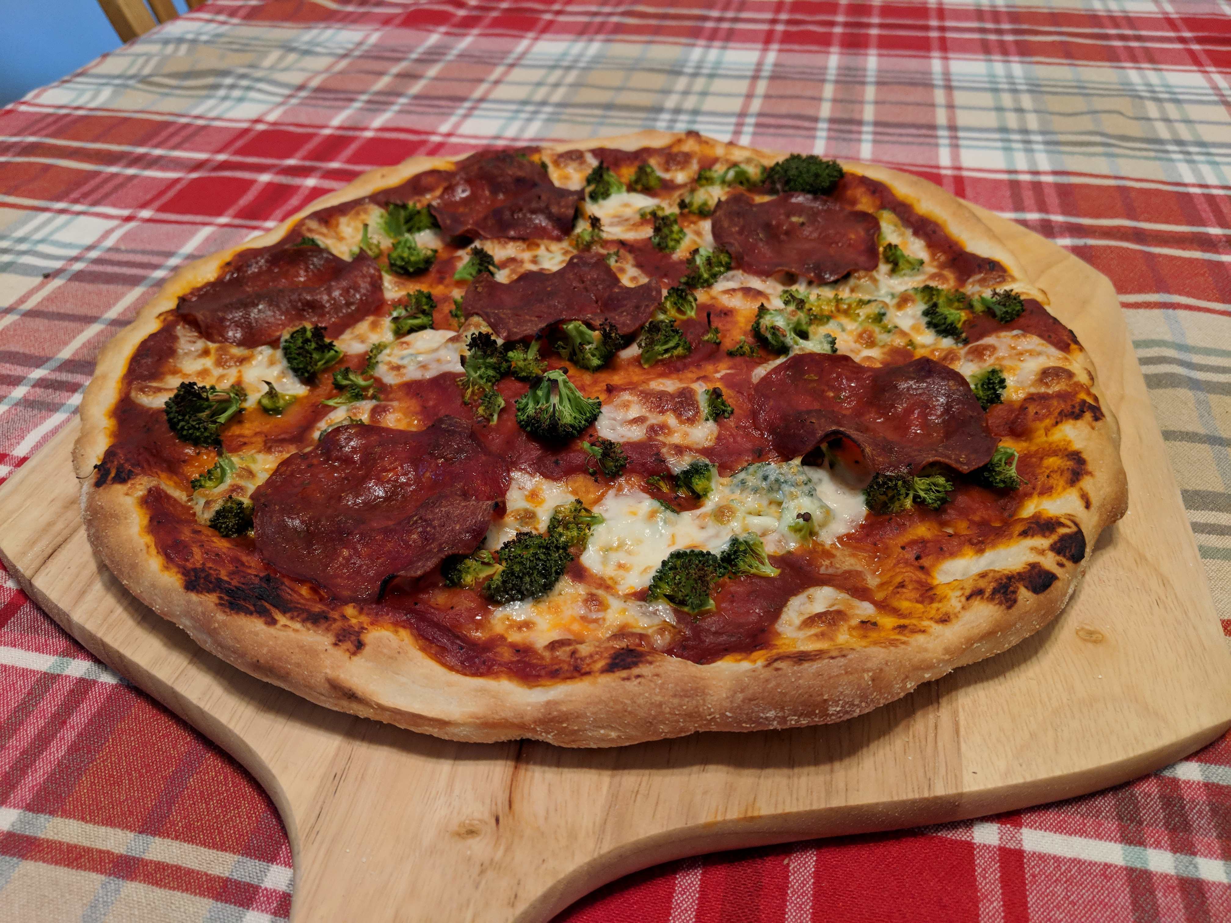 A broccoli and sopressata pizza from a basic oven.